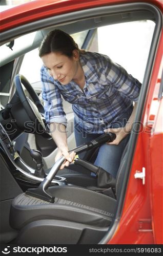 Woman Cleaning Inside Of Car Using Vacuum Cleaner