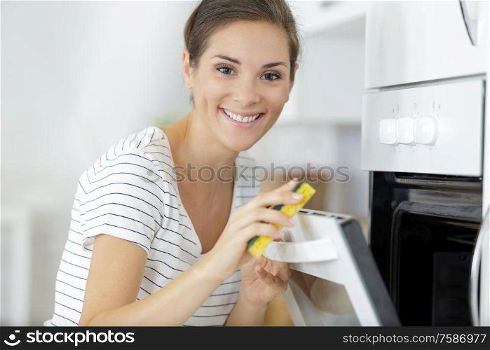 woman cleaning inside the oven