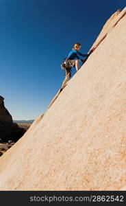 Woman Climbing up Cliff