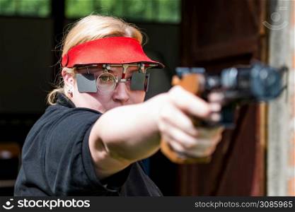 Woman concentrating on sport shooting training