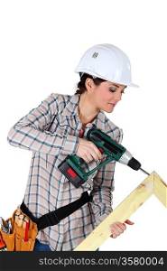 Woman constructing wooden frame