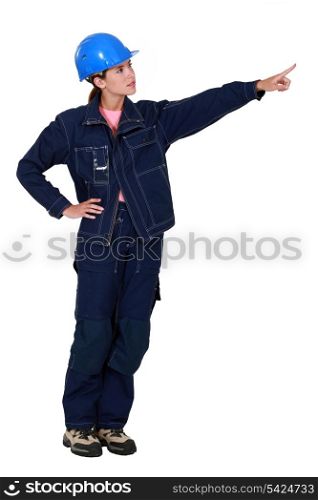 Woman construction worker showing something