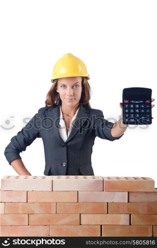 Woman construction worker with calculator on white