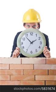 Woman construction worker with clock on white
