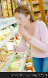 Woman contemplating at chilled counter