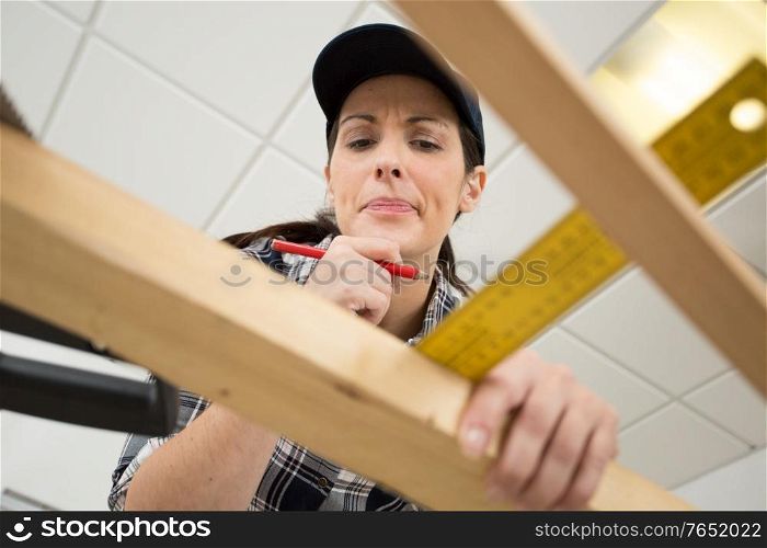 woman contemplating her carpentry project