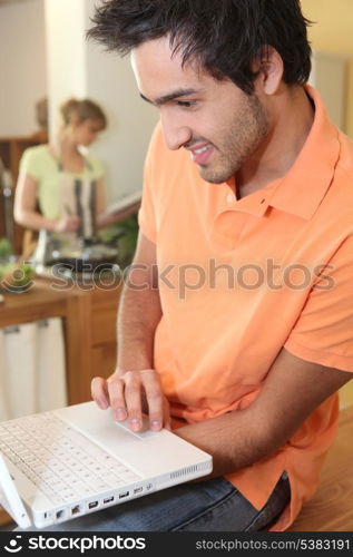 woman cooking and man with computer