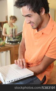 woman cooking and man with computer