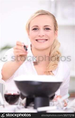Woman cooking fondue
