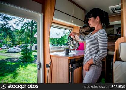 Woman cooking in camper, motorhome interior. Family vacation travel, holiday trip in motorhome RV, Caravan car Vacation.
