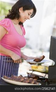 Woman Cooking On A Barbeque