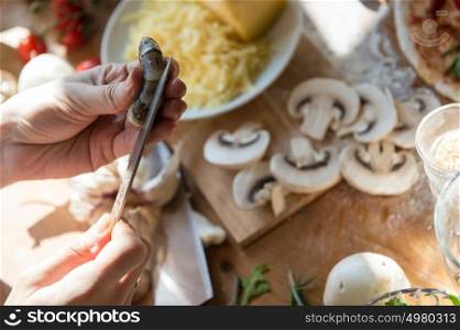 Woman cooking pizza at home. Unrecognizable woman cutting shrimp