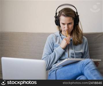 woman couch paying attention online class