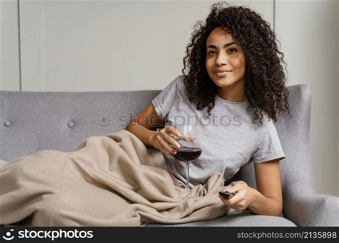 woman couch watching tv drinking wine