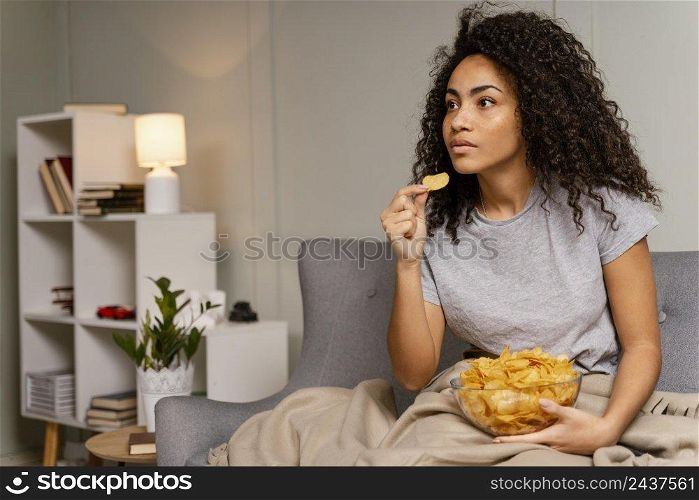 woman couch watching tv eating chips 5