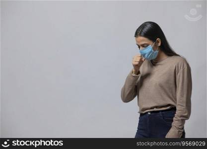 Woman coughing with a mask on her face