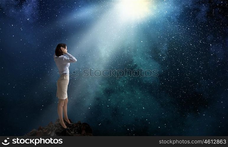 Woman cover ears. Young woman covering her ears with hands and looking in night sky