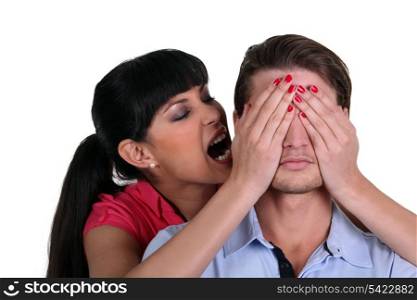Woman covering a man&rsquo;s eyes