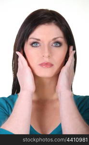 Woman covering ears