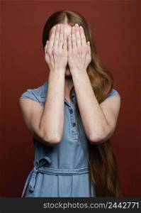woman covering face with hands
