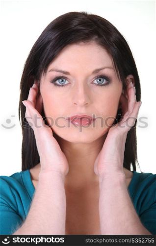 Woman covering her ears