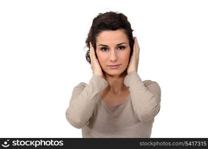 Woman covering her ears