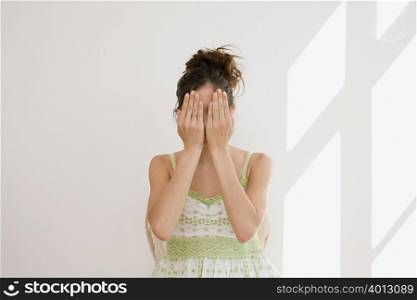 Woman covering her face with hands