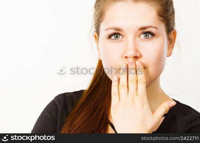 Woman covering her mouth with hand. Seeing something shocking, surprised and speechless face expression.. Woman covering her mouth with hand