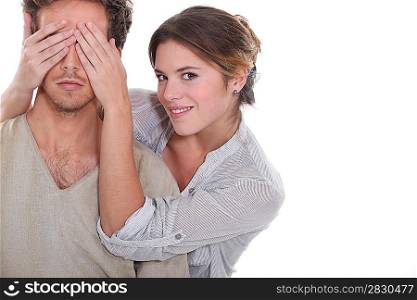 Woman covering partners eyes