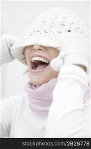 Woman covering the face with a knit hat