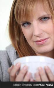 Woman cradling a breakfast bowl in her hands