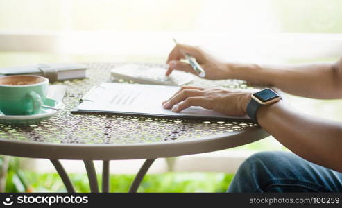 woman creative business using calculator at a outdoor cafe