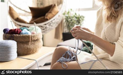 woman crocheting indoors