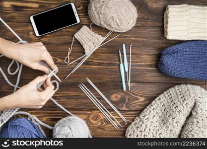 woman crocheting wooden background
