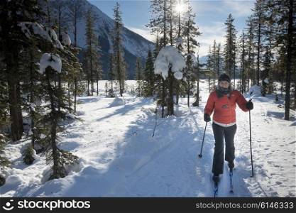 Woman cross country skiing, Emerald Lake, Field, British Columbia, Canada