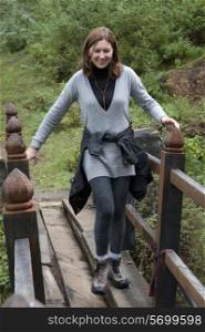 Woman crossing a footbridge, Paro Valley, Paro District, Bhutan