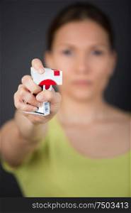 woman crushing cigarette packet in outstretched hand