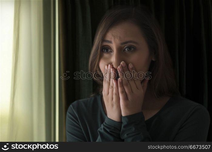 Woman crying with hand over mouth