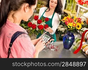 Woman customer paying flowers shop credit card florist roses
