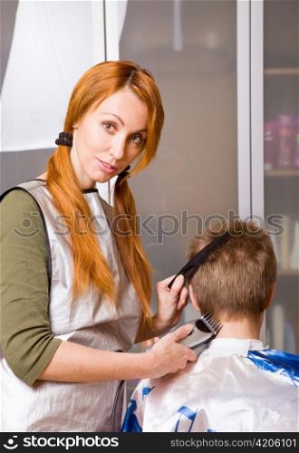 Woman cutting a boy's hair