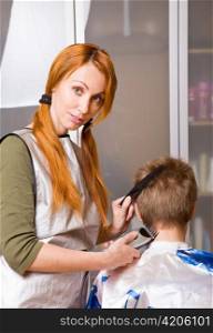 Woman cutting a boy's hair