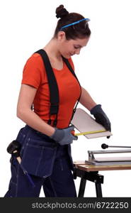 Woman cutting a tile