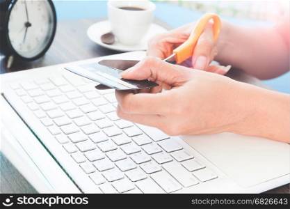 Woman cutting credit card, Online shopping concept