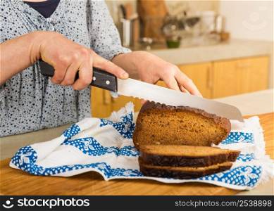 Woman cutting slices of gluten-free bread