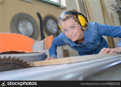 woman cutting wood