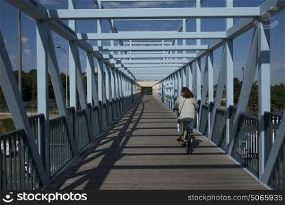 Woman cycling on Irene Hixon Whitney Bridge in Minneapolis, Hennepin County, Minnesota, USA