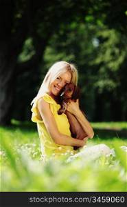 woman dachshund in her arms on grass