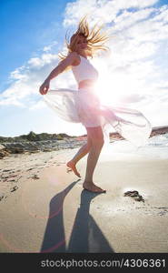 Woman dancing on beach