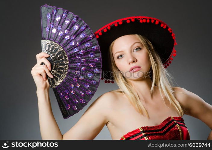 Woman dancing with fans in arts concept