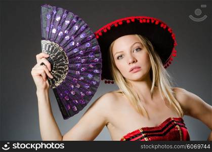 Woman dancing with fans in arts concept